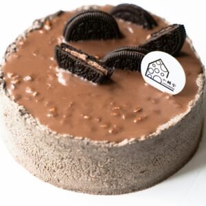 A rich chocolate cake topped with cookies, perfect for dessert lovers.
